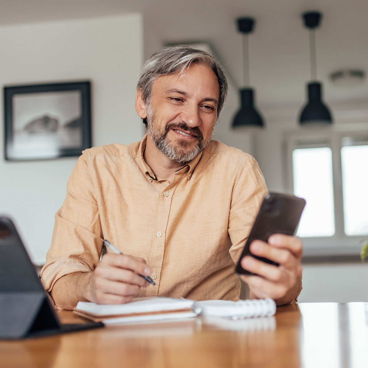 Homeowner reviewing checking account on mobile device